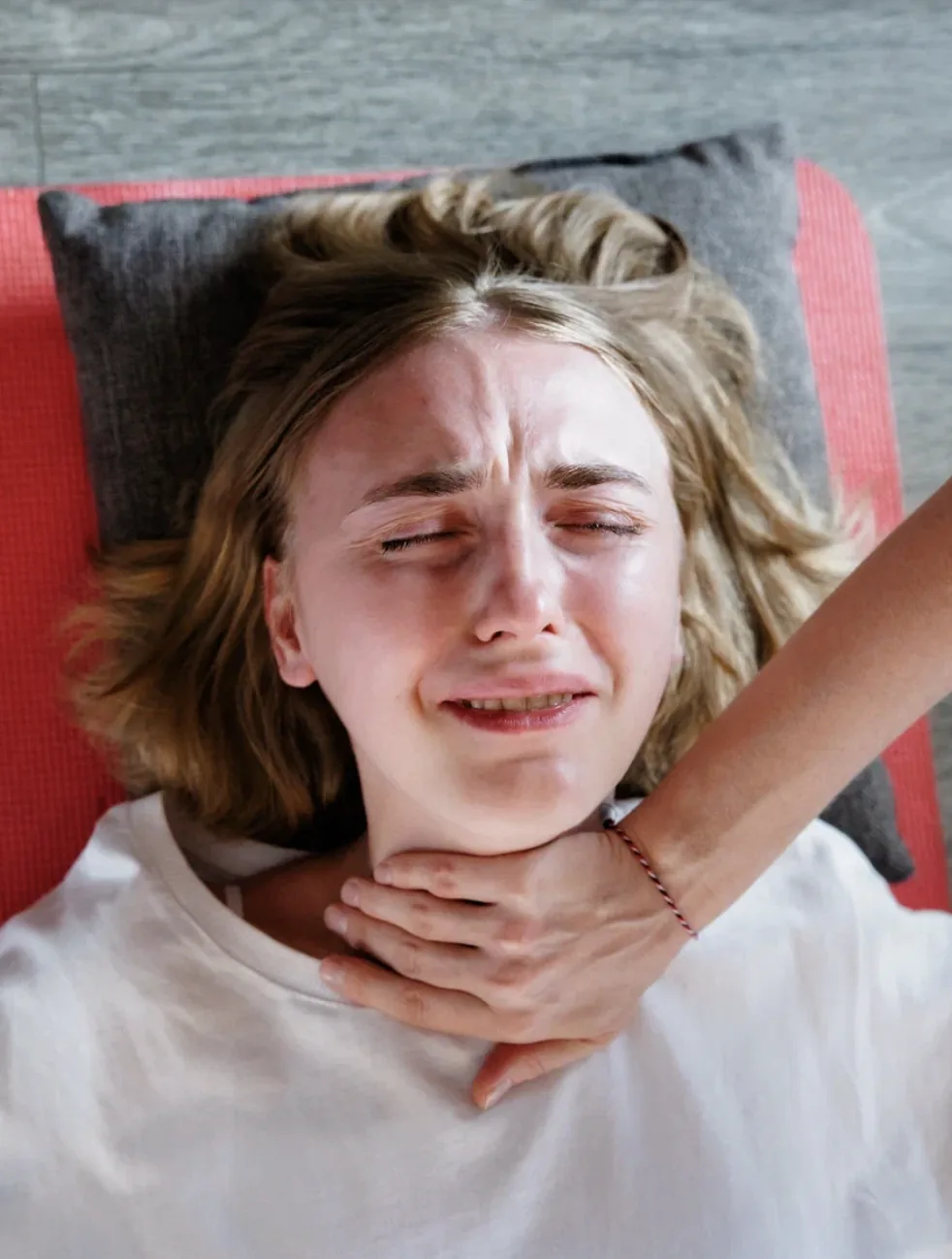 A participant in tears during a session, the facilitator's hand supporting her