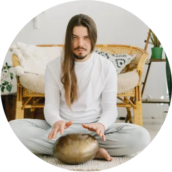man is playing tongue drum sound healing instrument