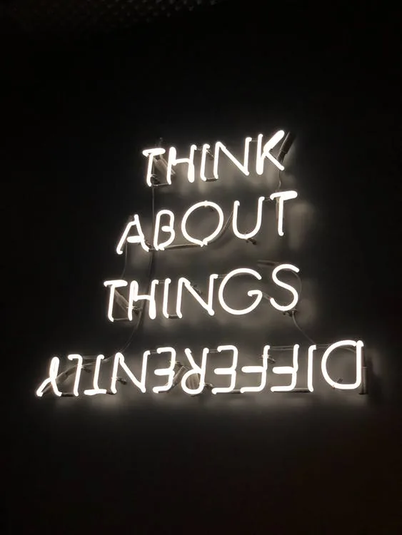 Think abut things differently neon sign. Be creative, think outside of the box, awaken.