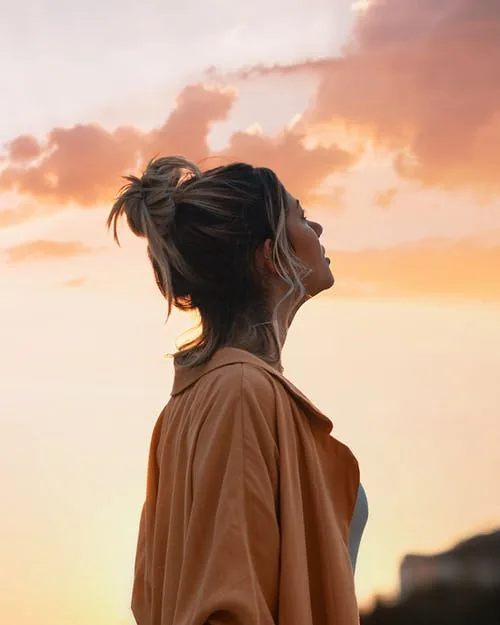 woman staring at the sky practicing self awareness 