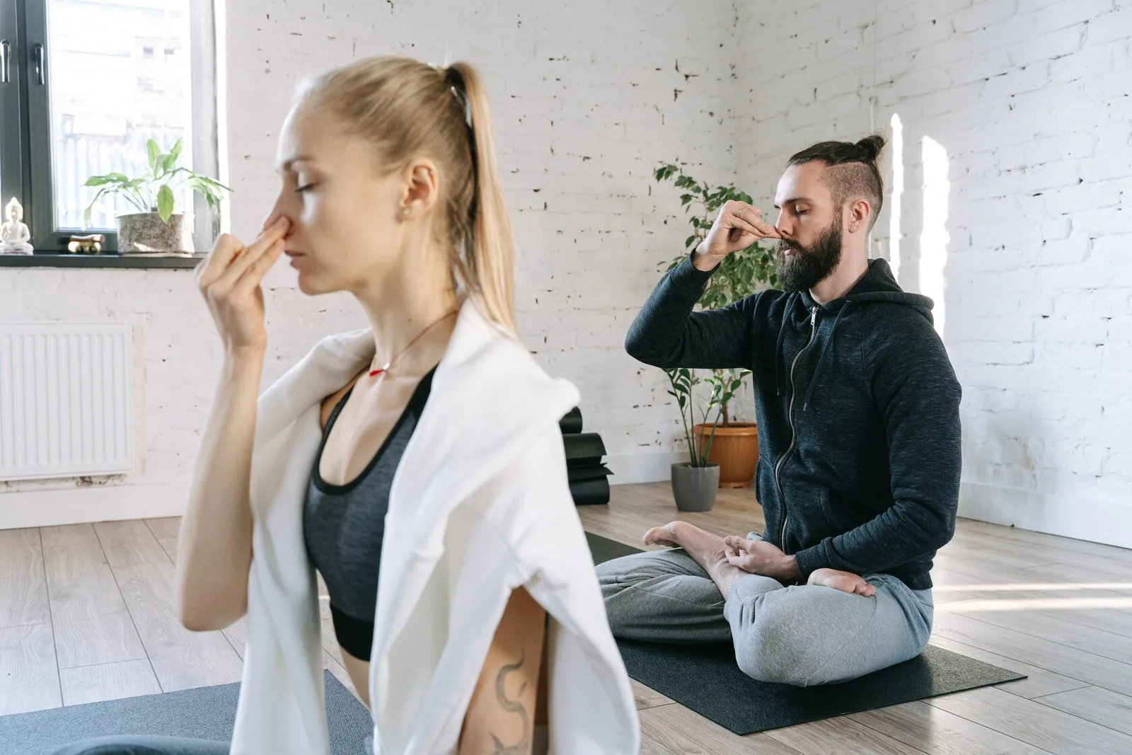 man and woman breathing, practicing yoga breath, pranayama, nostril breathing