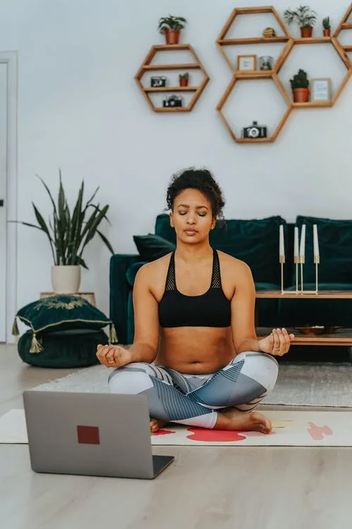 woman taking virtual online meditation retreat at home