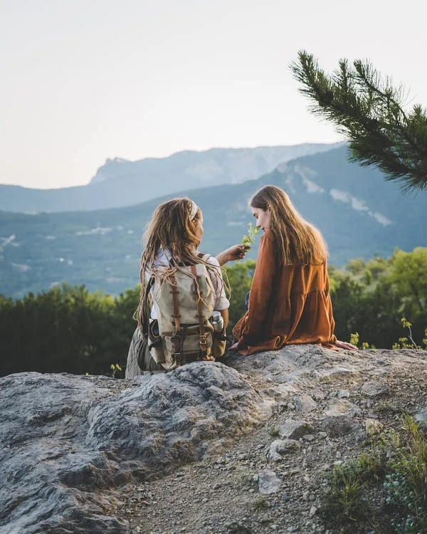 two women on a top of the mountain smelling herbs, sage, palo santo, plant medicine, ayahuasca, sacred plants, herbs for healing 